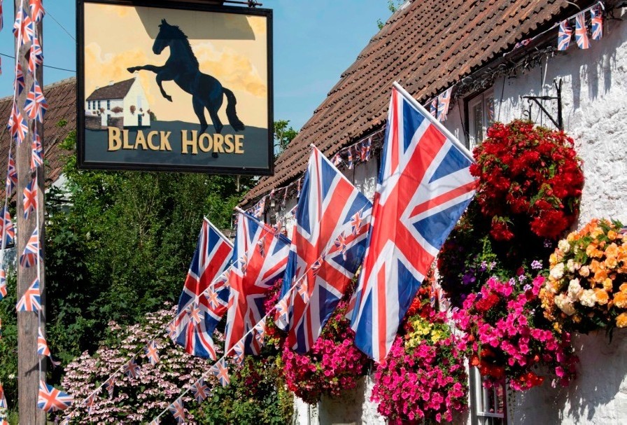 Black Horse pub, Clapton-in-Gordano with inn sign and hanging baskets